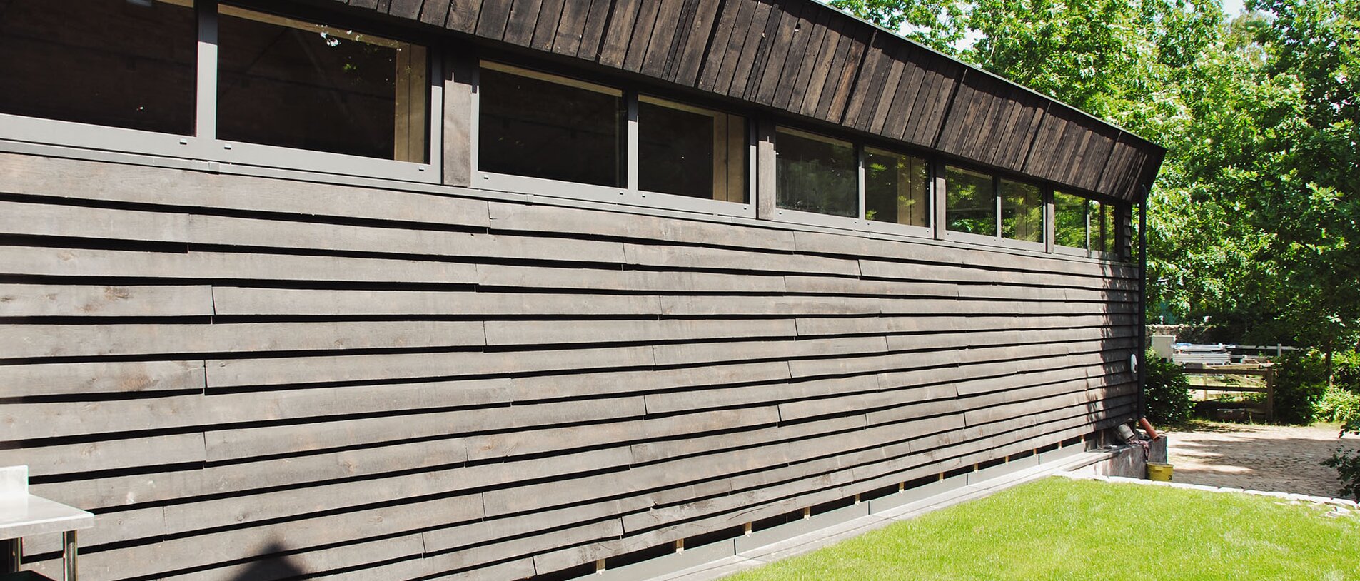 Tanzschule am Eichberg – Seitenfassade mit dunkler Holzschalung, befestigt mit LIGNOLOC® Holznägeln von BECK