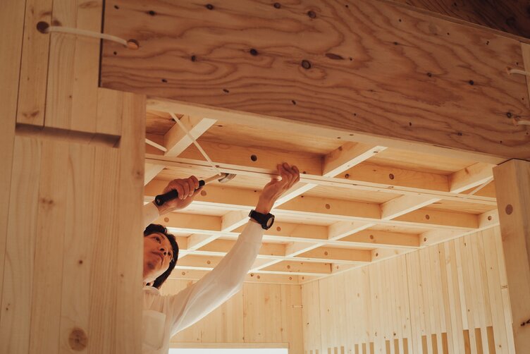 Working on the pavilion’s ceiling beams